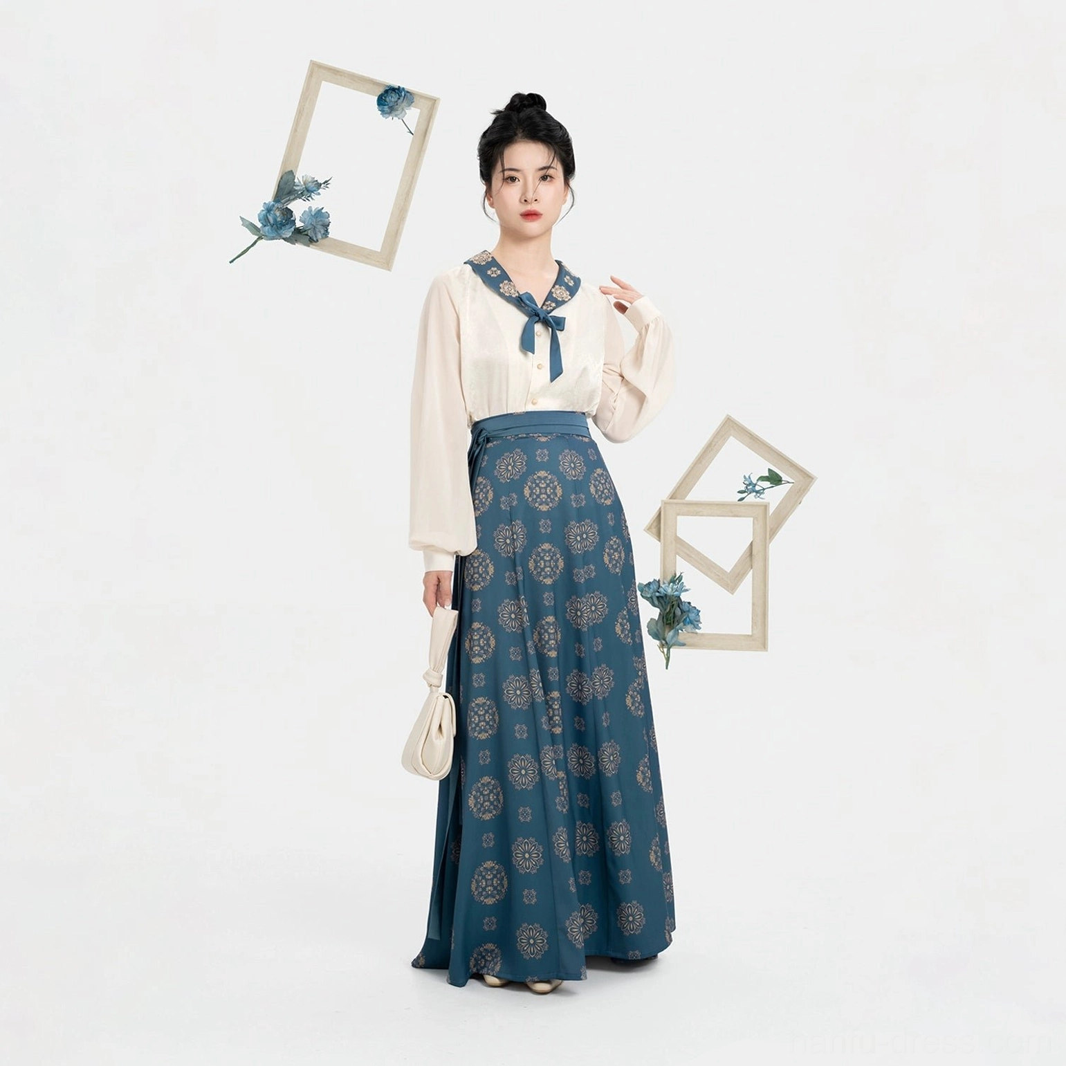Full-body front view of a Dailan Tang Dynasty modern hanfu set with cream blouse, flowing navy floral nine-panel skirt, traditional updo, and elegant daily wear styling