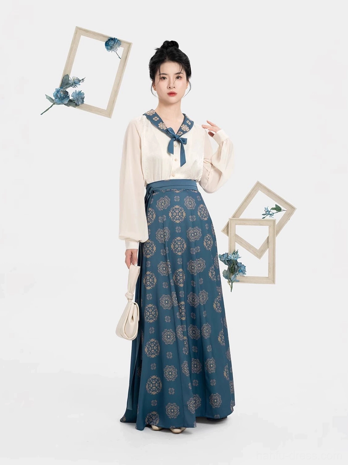 Front view of a Dailan Tang Dynasty modern hanfu set with cream long sleeve top, navy nine-panel wrap skirt, floral motifs, traditional Chinese hairstyle, and elegant studio styling