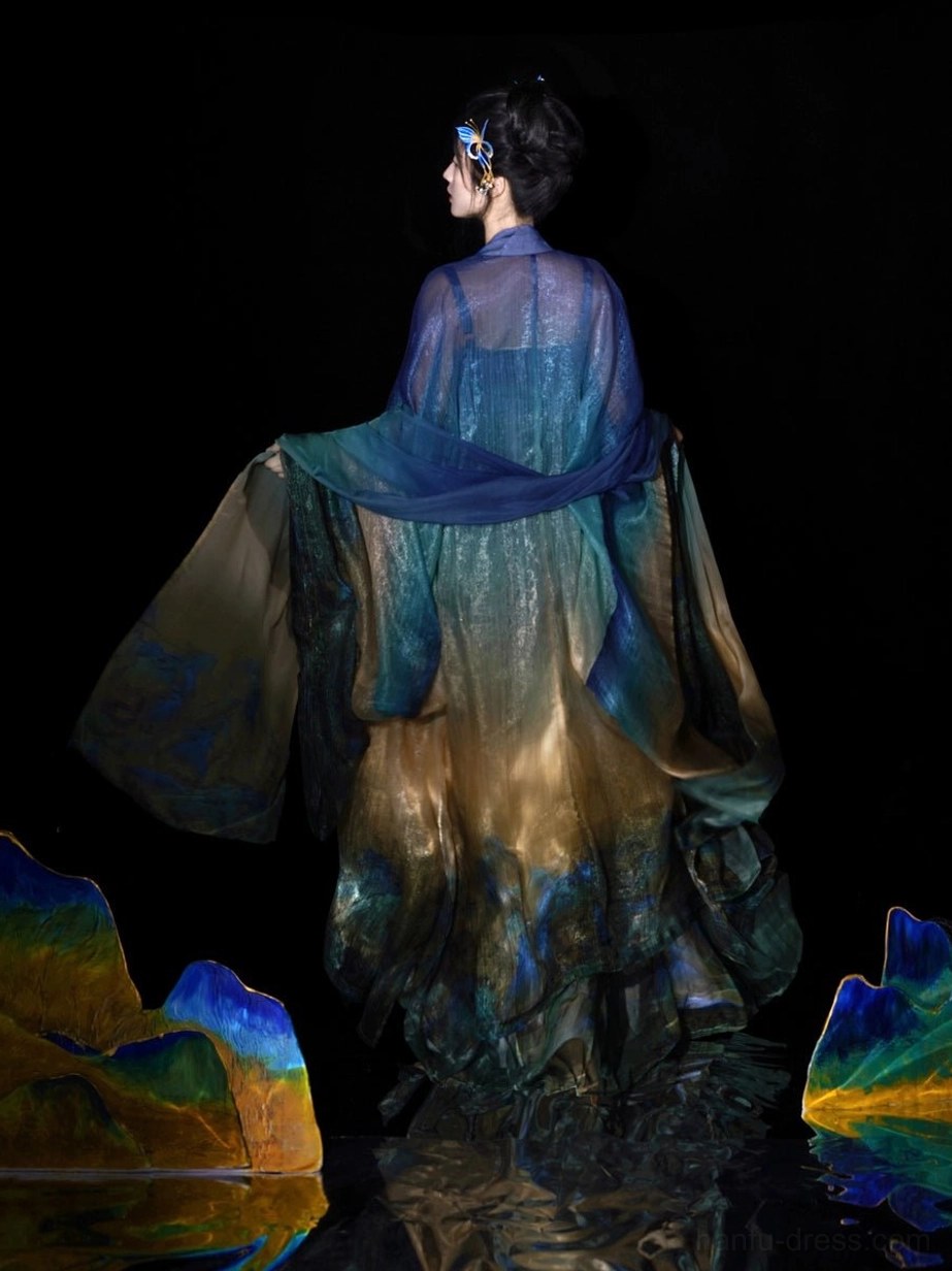 Back view of a flowing Daisy Blue Tang Dynasty Hanfu dress with sheer outer robe landscape print skirt and tied waist sash