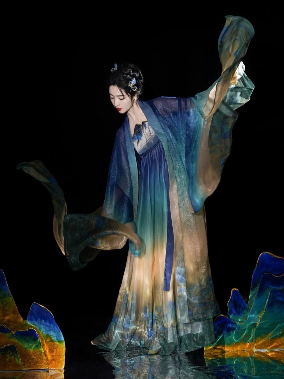 Tang Dynasty Hanfu dress in a dynamic side view with fluttering big sleeves floor length landscape print skirt and matching sash