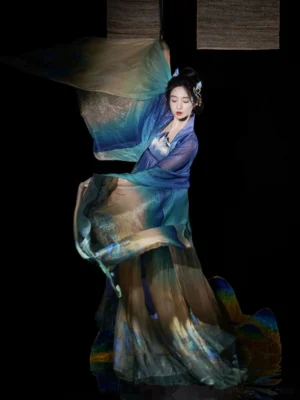 Daisy Blue Tang Dynasty Heziqun Hanfu dress shown from a three quarter side angle with flowing sheer gradient sleeves and landscape print