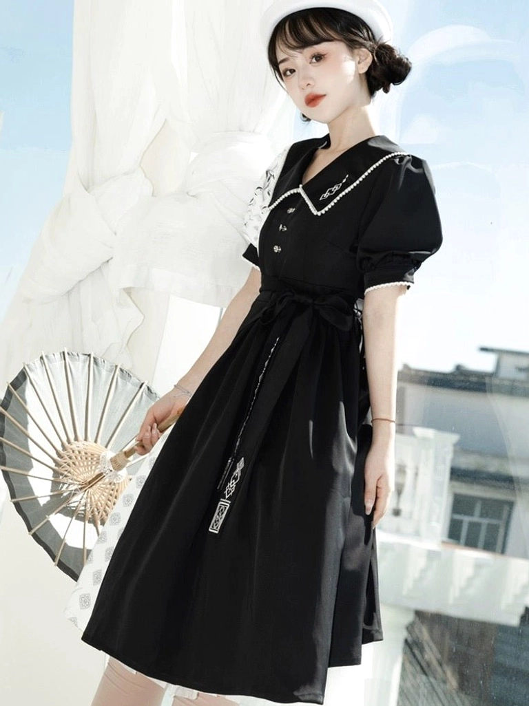 Three-quarter side view of black cheongsam-style Modern Hanfu dress featuring white embroidered collar trim, puff sleeves, embroidered skirt, and matching sash