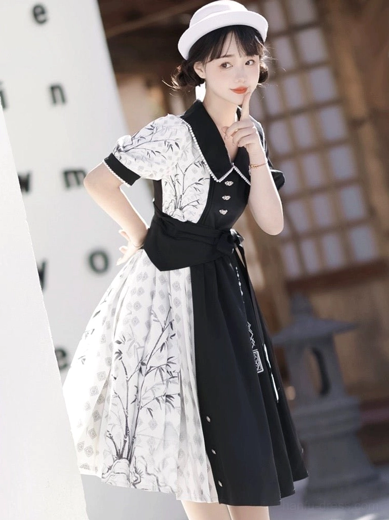 Three-quarter front view of black and white modern Hanfu cheongsam dress with ink bamboo print, embroidered panel, puff sleeves, and embroidered waist sash