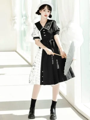 Full-length front view of modern Hanfu cheongsam-style midi dress with contrast black and white panels, decorative buttons, puff sleeves, and waist sash