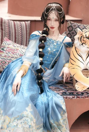 Close seated view of Dancing Jasmine modern Hanfu off shoulder top with gold floral embroidery blue satin fabric and sheer sleeves
