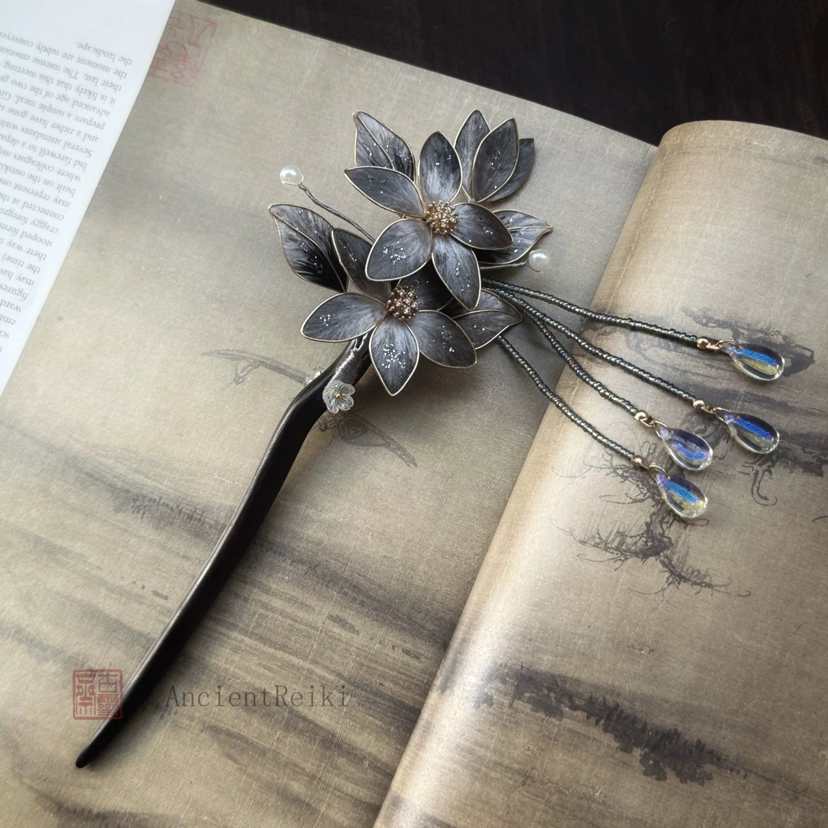 Danqing traditional Chinese decorative hair pin shown from an alternate angle, featuring a black stick shaft, compact lotus flower ornament and beaded tassel