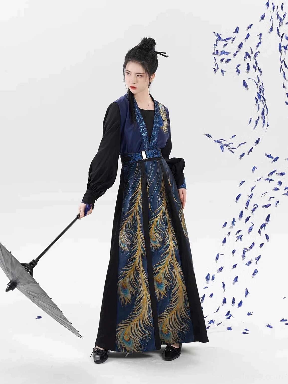 Side view of a dark blue and black Tang Dynasty inspired hanfu outfit styled with an oiled paper umbrella and flowing eight-panel skirt