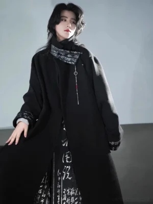 Three-quarter front view of a dark calligraphy Hanfu robe coat with silver lapel details, tassel pendant, and matching skirt
