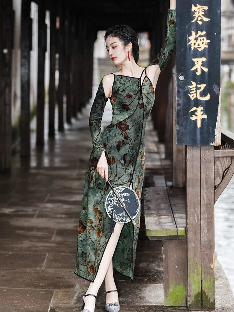 Dark green velvet-look modern Hanfu dress with brown floral branches, slim fit, high side slit, and vintage styling worn with heels in a covered riverside corridor