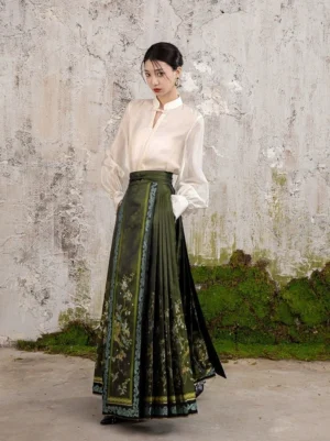 Modern Chinese Hanfu horse face skirt shown from the front right side with dark green pleats, floral patterns, ornate woven borders, and traditional styling