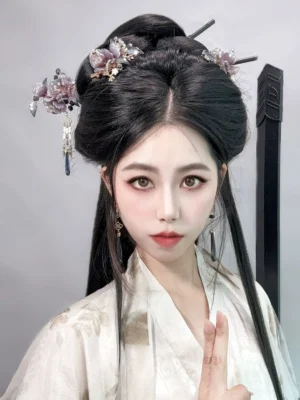 Woman wearing a beige Song-style Hanfu outfit with dark purple floral hair accessories secured in a traditional coiled updo for an elegant historical Chinese fashion look