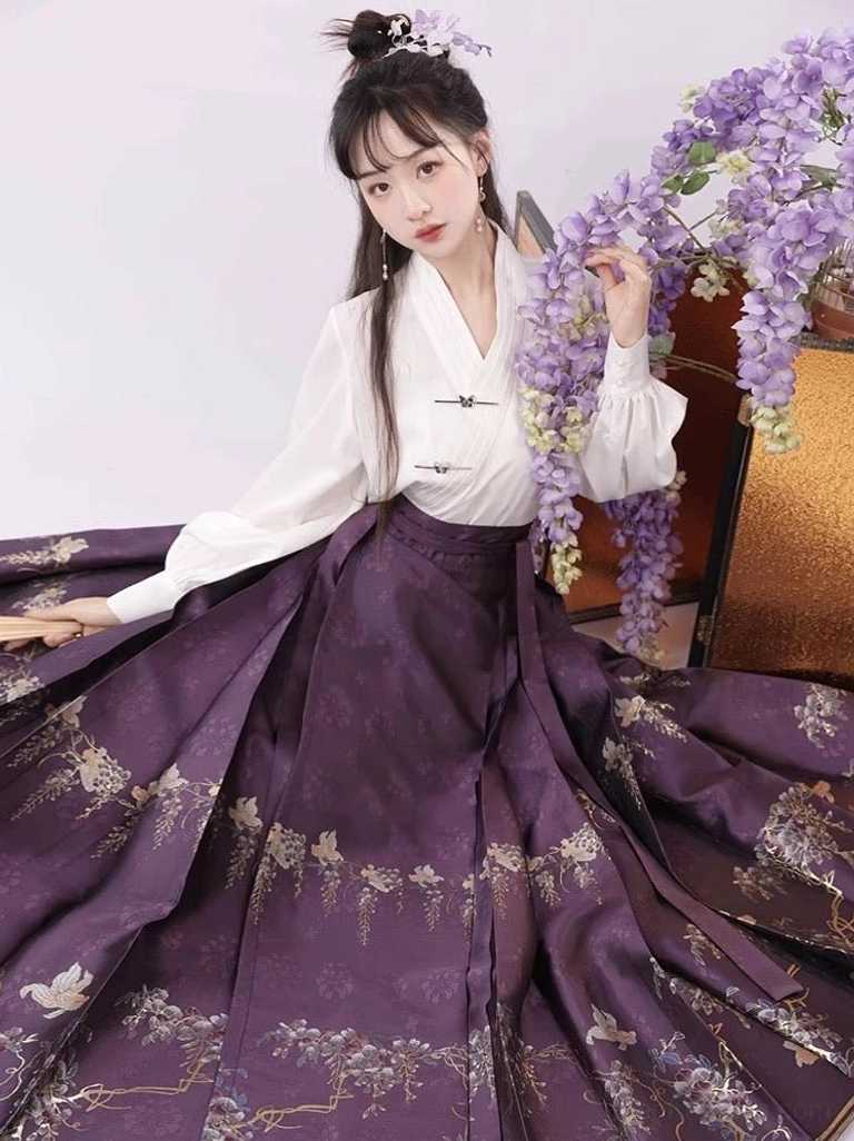 Dark purple Ming Dynasty-inspired mamianqun horse face skirt with full pleats, large golden floral and wisteria patterns, and flowing hem