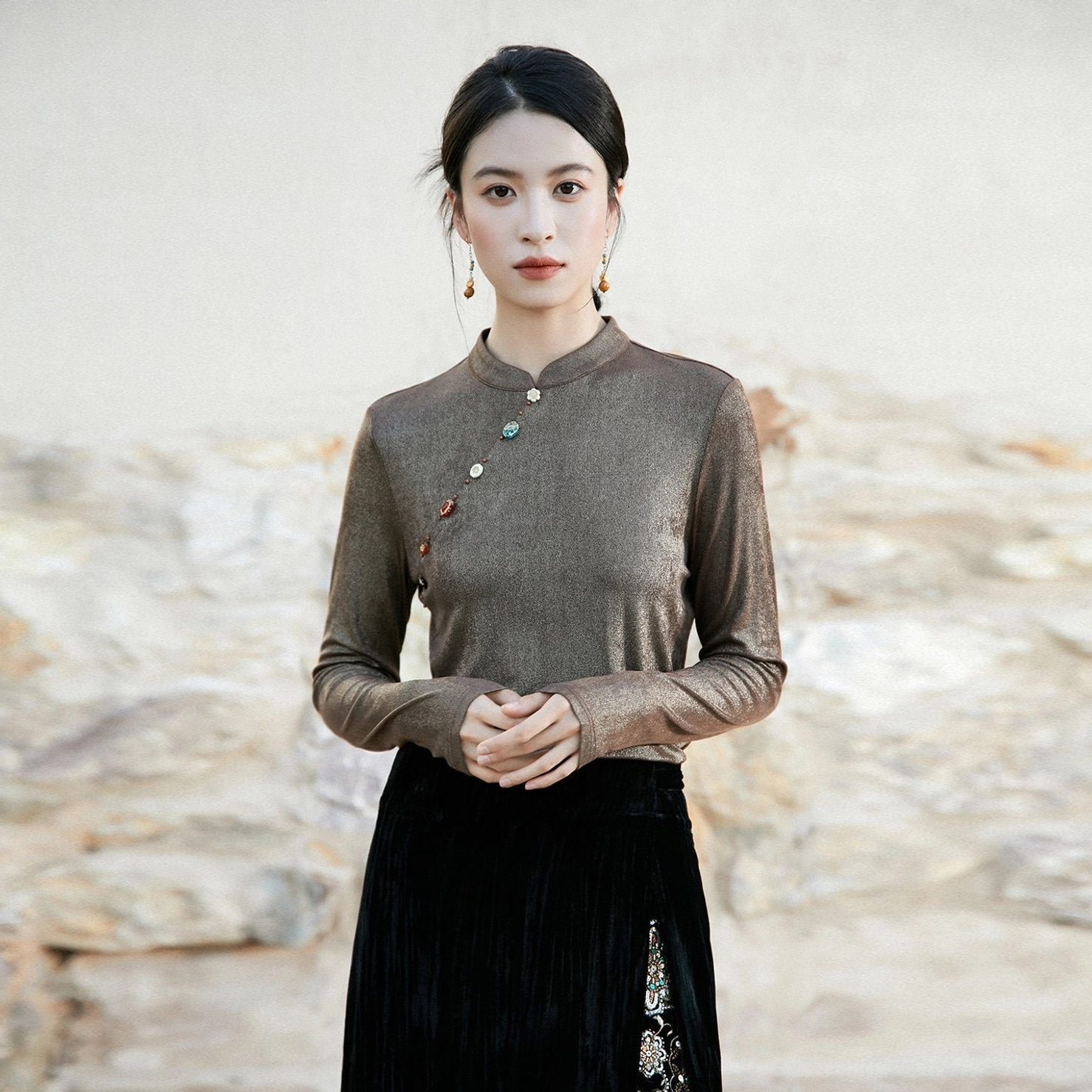 Dark taupe women’s modern Hanfu satin shimmer top with upright stand collar, decorative diagonal buttons, and black embroidered skirt outfit