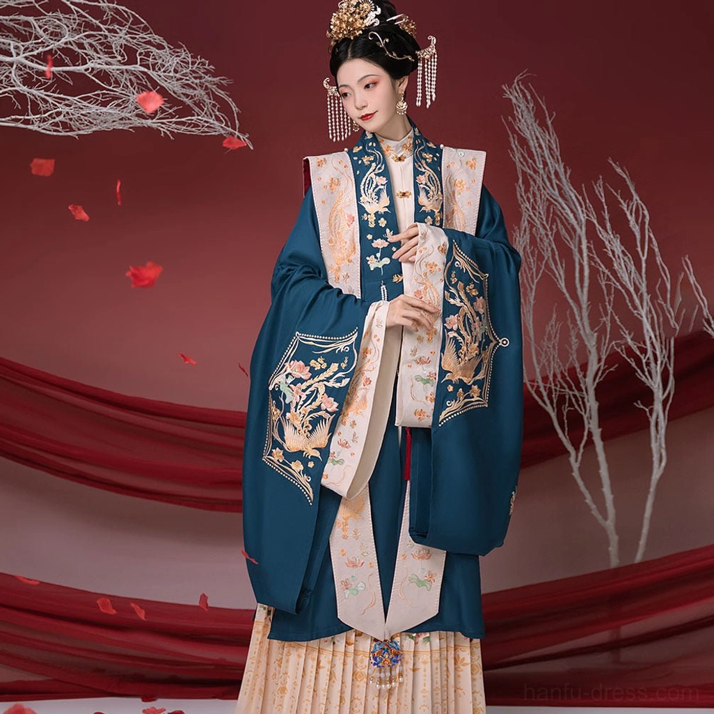 Front medium full-length view of a dark teal Ming Dynasty Hanfu bridal inner set with gold phoenix embroidery on the collar and cuffs, off-white xiapei sashes, and cream pleated skirt