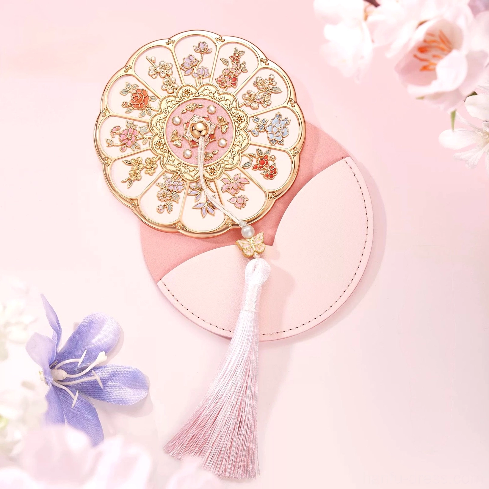Decorative Chinese hand mirror with gold-toned floral frame, pink tassel, and two-tone pink protective storage pouch