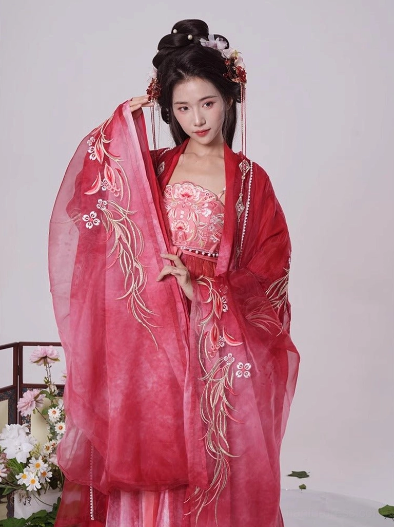 Deep crimson red Tang Dynasty Hanfu Heziqun dress shown from the front with elaborate golden embroidery on the sleeves and chest and a dramatic wide-sleeve coat