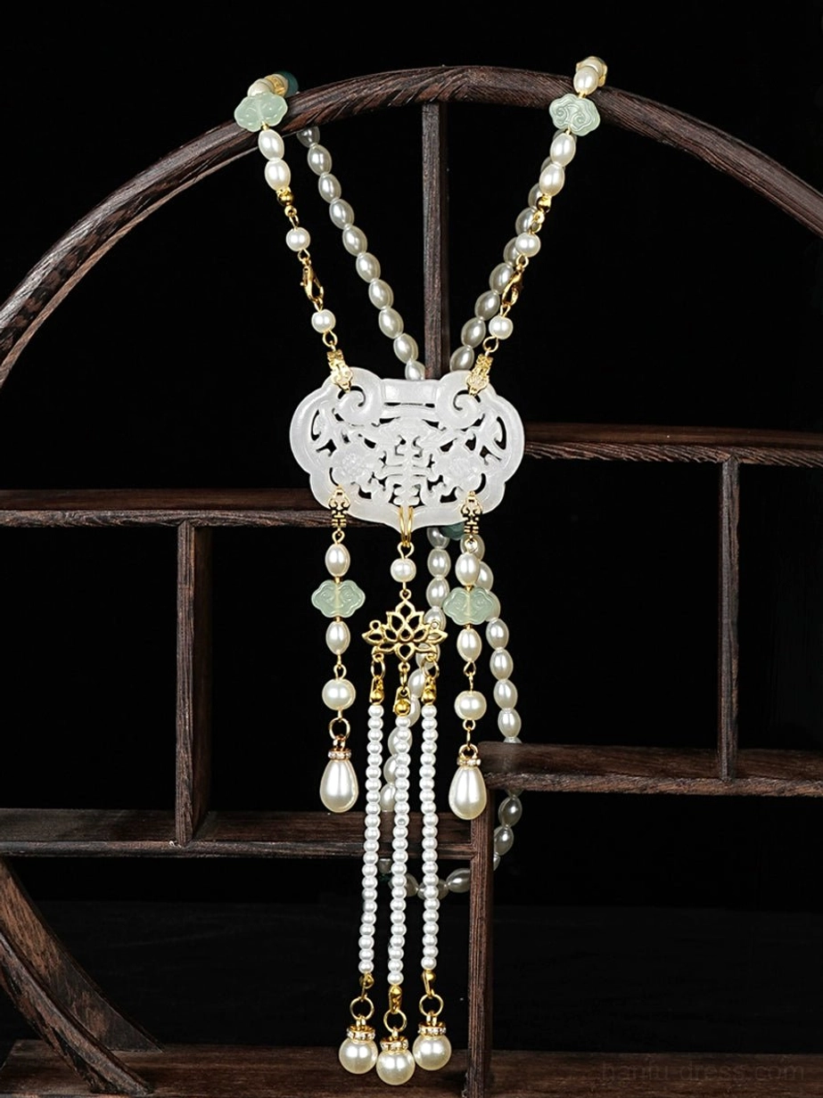 Delicate Chinese necklace with hollow white longevity lock, layered gold and pearl-like chains, light green jade decorations, and multi-layer pearl tassel pendants