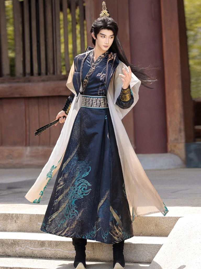 Side view of men's Chinese fantasy hanfu with off white outer robe, navy patterned gown, waist sash and folding fan on stone steps
