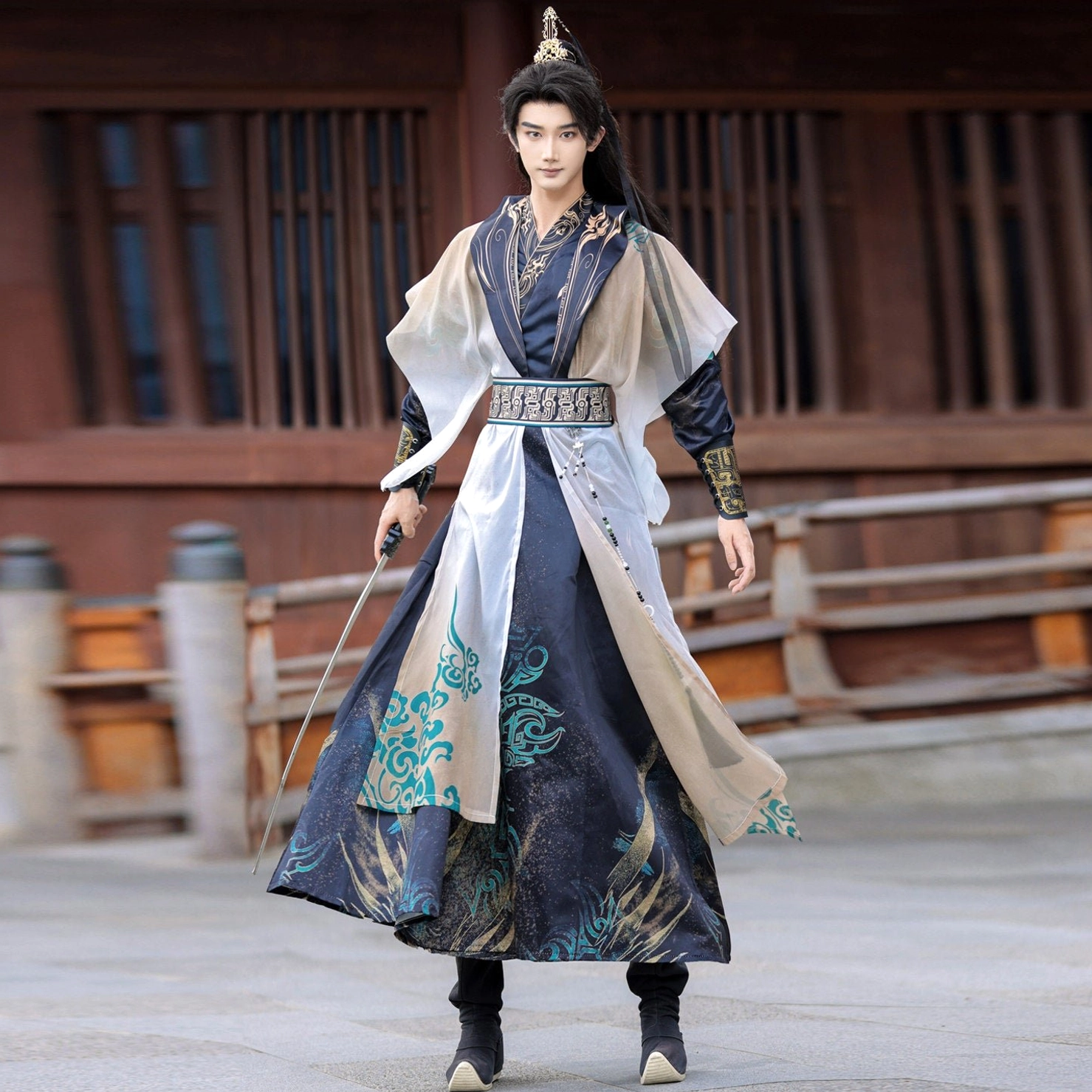 Low angle full body view of Depths of Heaven men's wuxia hanfu set with layered sheer robe, decorated waist sash and sword
