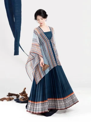 Front full-body view of a Dong-inspired modern Hanfu dress set with light blue geometric shawl, dark blue pleated skirt, and ethnic-style hem trim