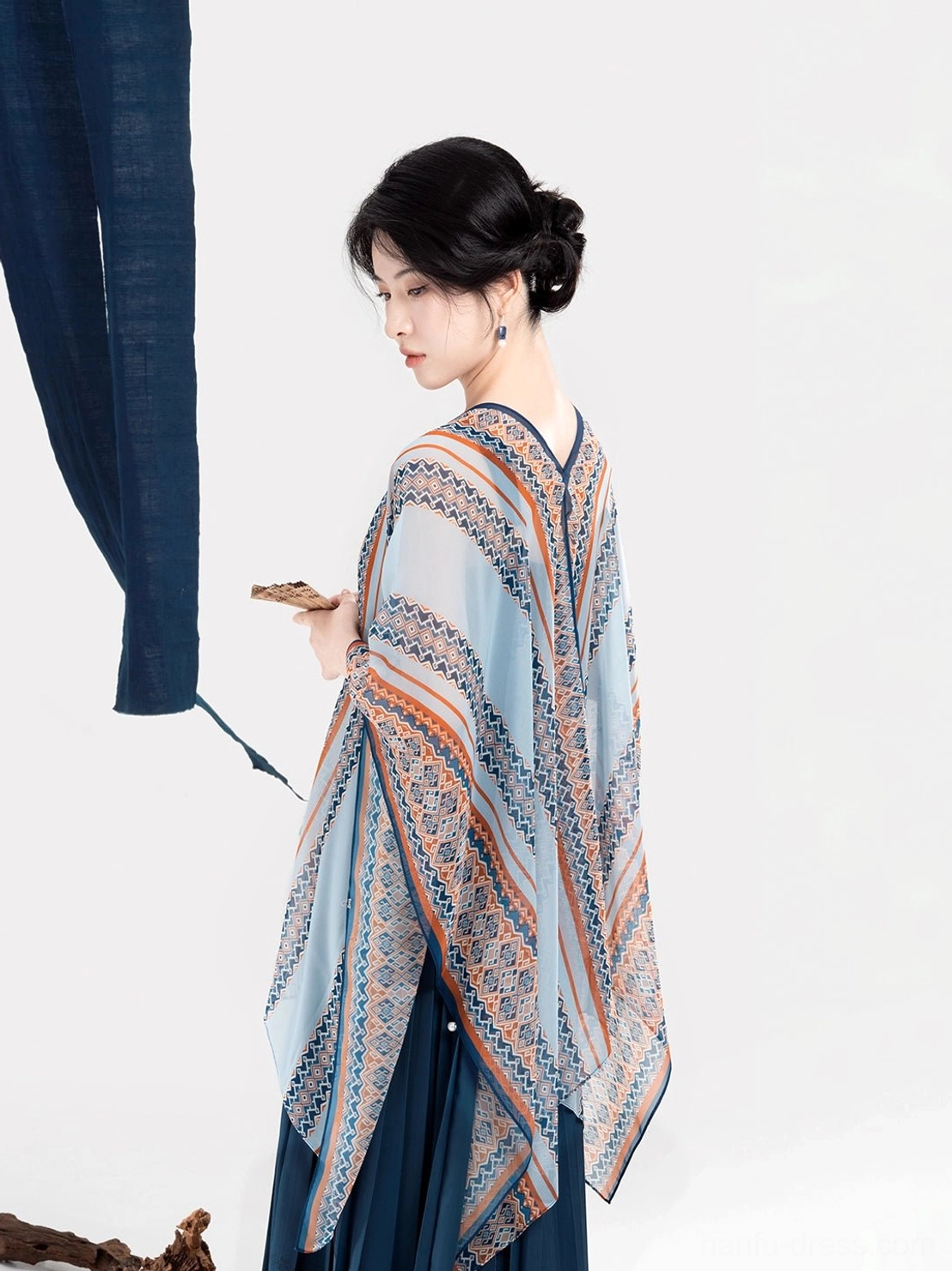 Rear side view showing the complete geometric pattern on the light blue shawl of a Dong-inspired modern Hanfu dress outfit