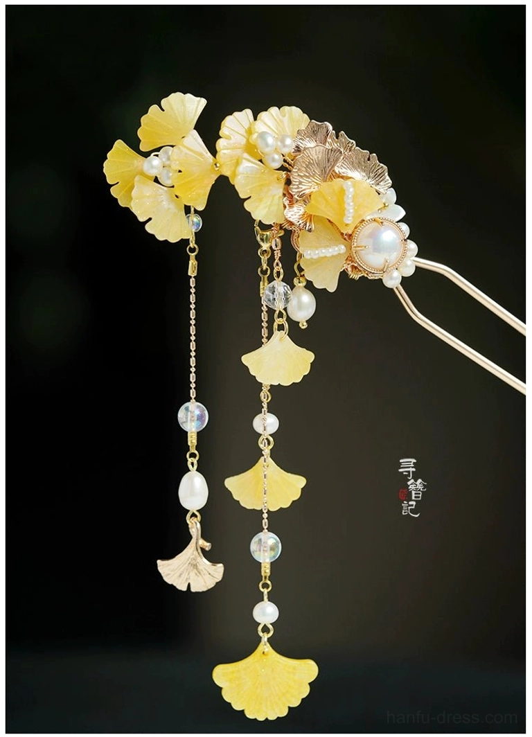 Double pronged golden ginkgo leaf tassel hairpin with rose gold tone frame, yellow leaves, pearls, and mixed glass bead ornaments