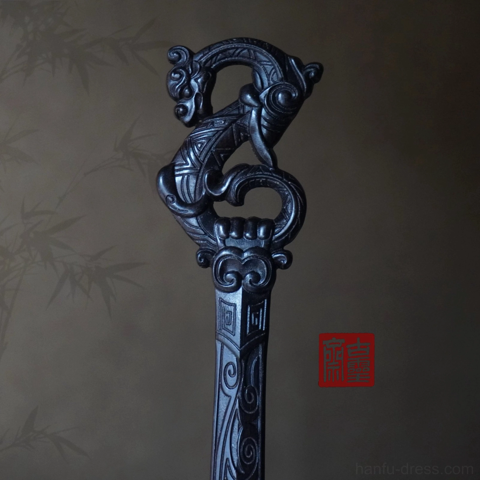 Close-up of the detailed dragon carving on a traditional Chinese hair stick with patterned shaft for Hanfu hair styling