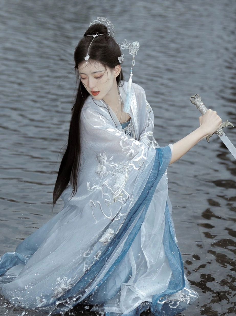Blue and white Tang Dynasty style Hanfu heziqun dress worn in water with embroidered outer robe, blue sash, and flowing long skirt