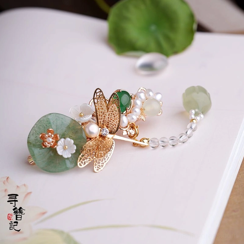 Side view of dragonfly lotus Chinese hair pin with extended dangling jade-toned crystal tassel and gold green white traditional hanfu hair accessory details