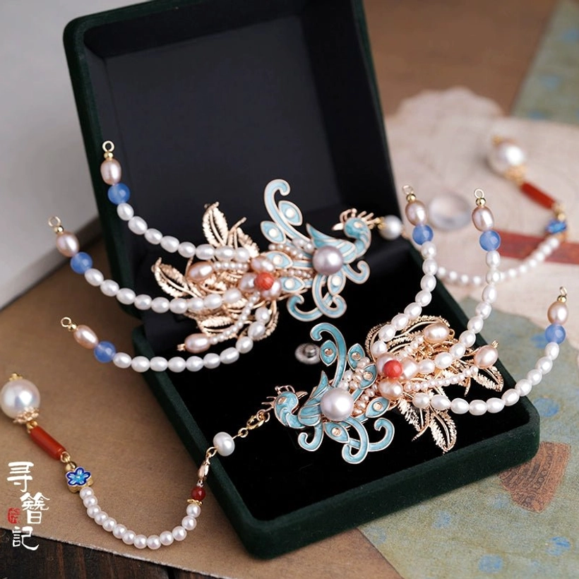 Dream of Red Mansion cloisonne phoenix pearl tassel hairpins displayed in a dark green velvet jewelry box