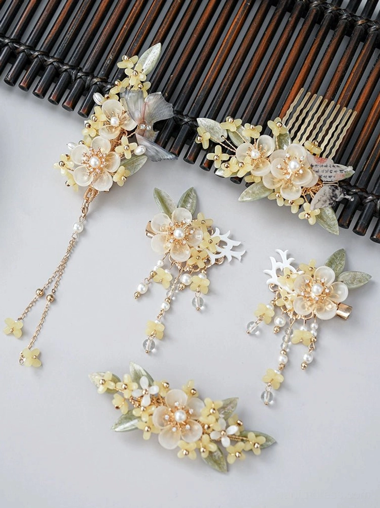 Complete Drunk Osmanthus Hanfu hair accessories set with cream floral hair combs, gold-tone hair clips, green leaves, pearl beads, and long tassel pendants displayed on a dark wooden background