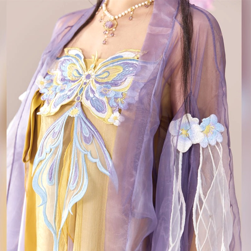 Close up of blue and gold butterfly embroidery on the golden dress with lavender sheer sleeve cuff of Tang Dynasty Hanfu