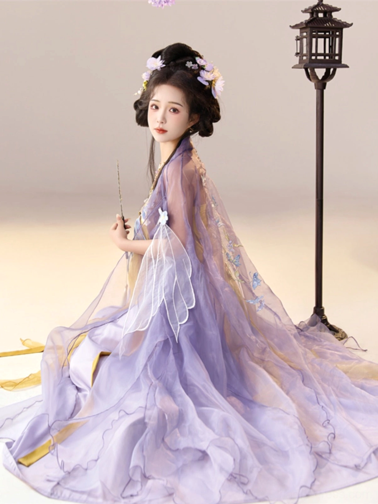Drunken Dream Butterfly Hanfu kneeling side view showing the long trailing lavender sheer robe and embroidered golden dress hem