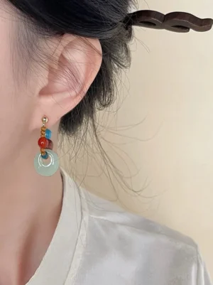 Pair of Dunhuang color palette Hanfu earrings featuring turquoise red blue and brown beads with pale jade tone circular pendants