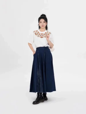 Full-body front view of a Dunhuang-inspired embroidered cotton T-shirt and navy maxi skirt modern Hanfu set styled with black combat boots