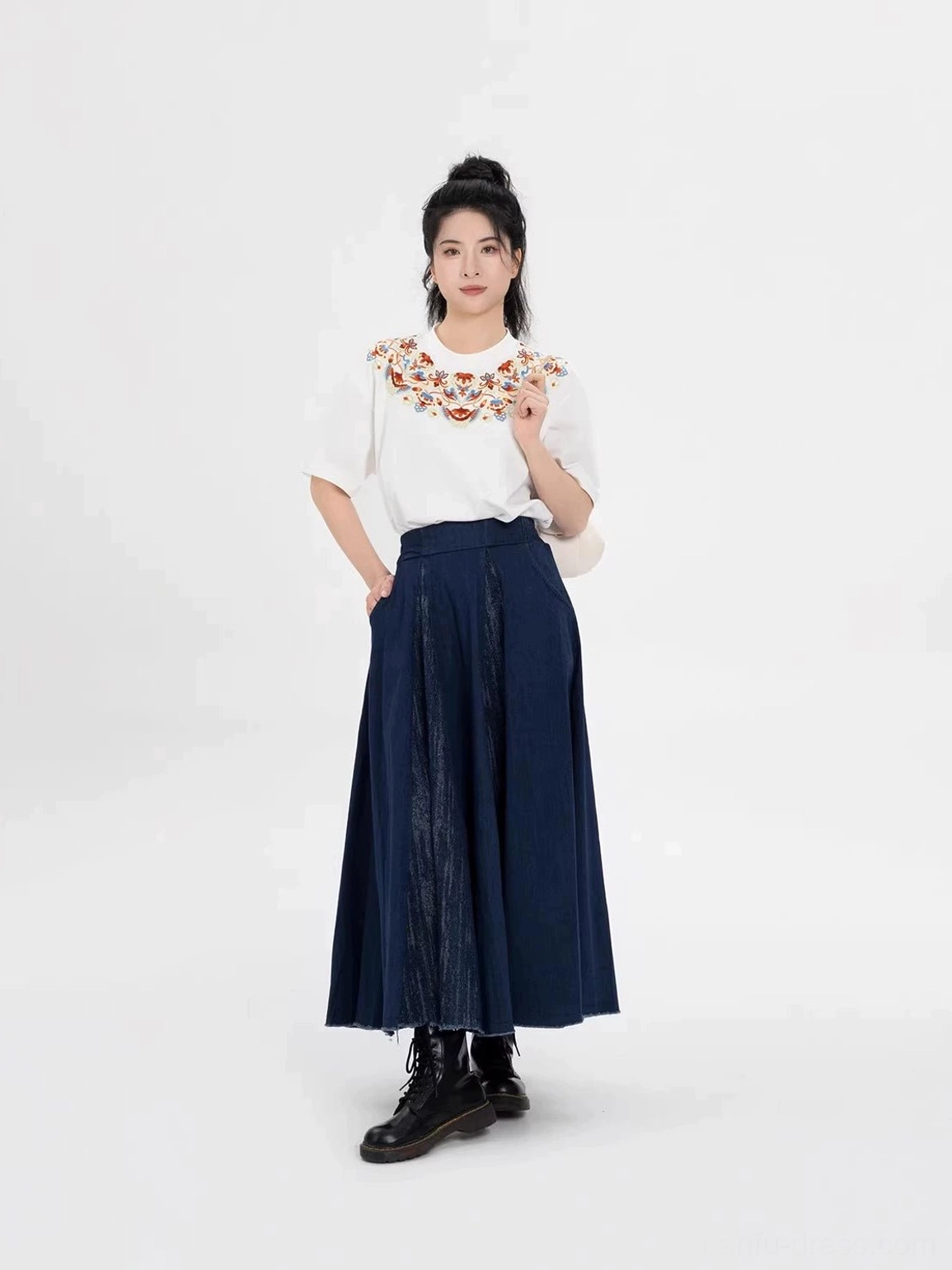 Full-body front view of a Dunhuang-inspired embroidered cotton T-shirt and navy maxi skirt modern Hanfu set styled with black combat boots