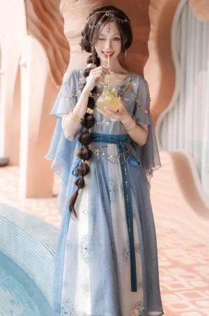 Dunhuang Feitian Hanfu dance dress styled with a flowing sheer shawl and gold jewelry beside a pool in a warm terracotta setting