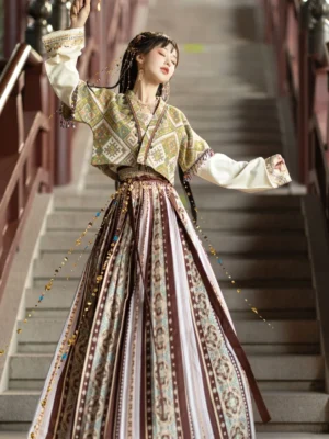 Dunhuang Feitian inspired modern Hanfu complete set shown in a front three-quarter view with a cropped printed vest, white inner sleeves, floor-length geometric skirt, and waist tassel decorations