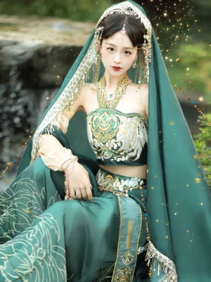 Front sitting close-up of a Dunhuang Feitian Tang Dynasty performance outfit with halter embroidered top, floral wide-leg bloomers, glittering green sheer veil, and retro gold jewelry