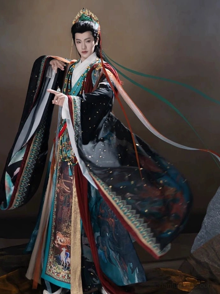 Complete Dunhuang mythical Hanfu set worn by male model with layered robe, beaded necklace, waist ornaments, and trailing silk head ribbons
