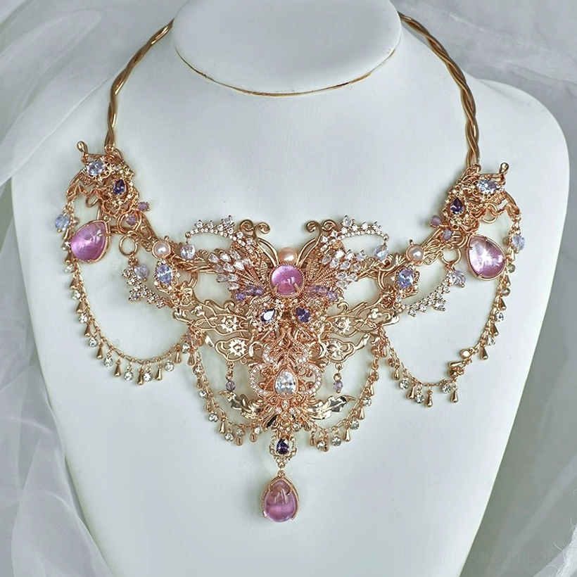 Dunhuang-inspired Hanfu necklace displayed on a jewelry mannequin, featuring vintage gold-tone carved floral patterns, pink-purple crystals, and a central dangling gemstone