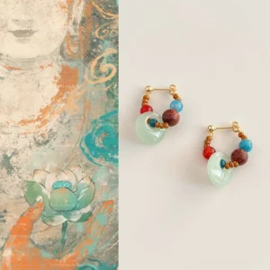 Dunhuang inspired Chinese loop earrings with antique gold tone hardware colorful beads and jade tone peace buckle charms on an off white background