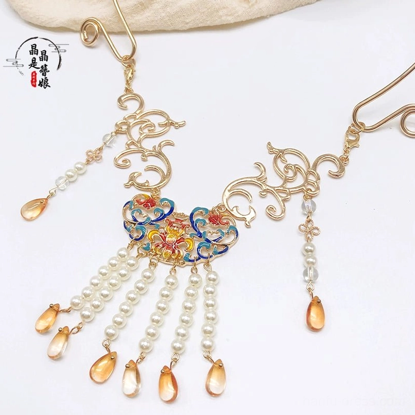 Front close-up of Dunhuang-inspired Chinese necklace featuring gold hardware, colorful floral enamel decoration, white pearl tassels, and amber pendants