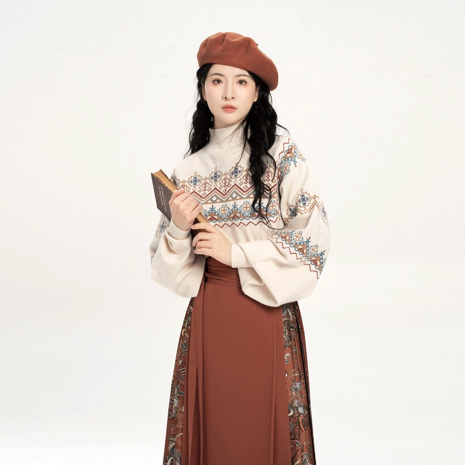 Close-up view of the Dunhuang-inspired sweater featuring intricate ethnic jacquard embroidery patterns around the upper body