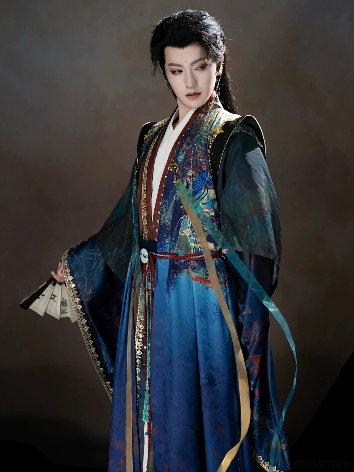 Three-quarter view of a male Dunhuang-inspired Xianxia Hanfu costume showing the flowing blue robe, layered front panels, wide sleeves, waist decorations, and fantasy character styling