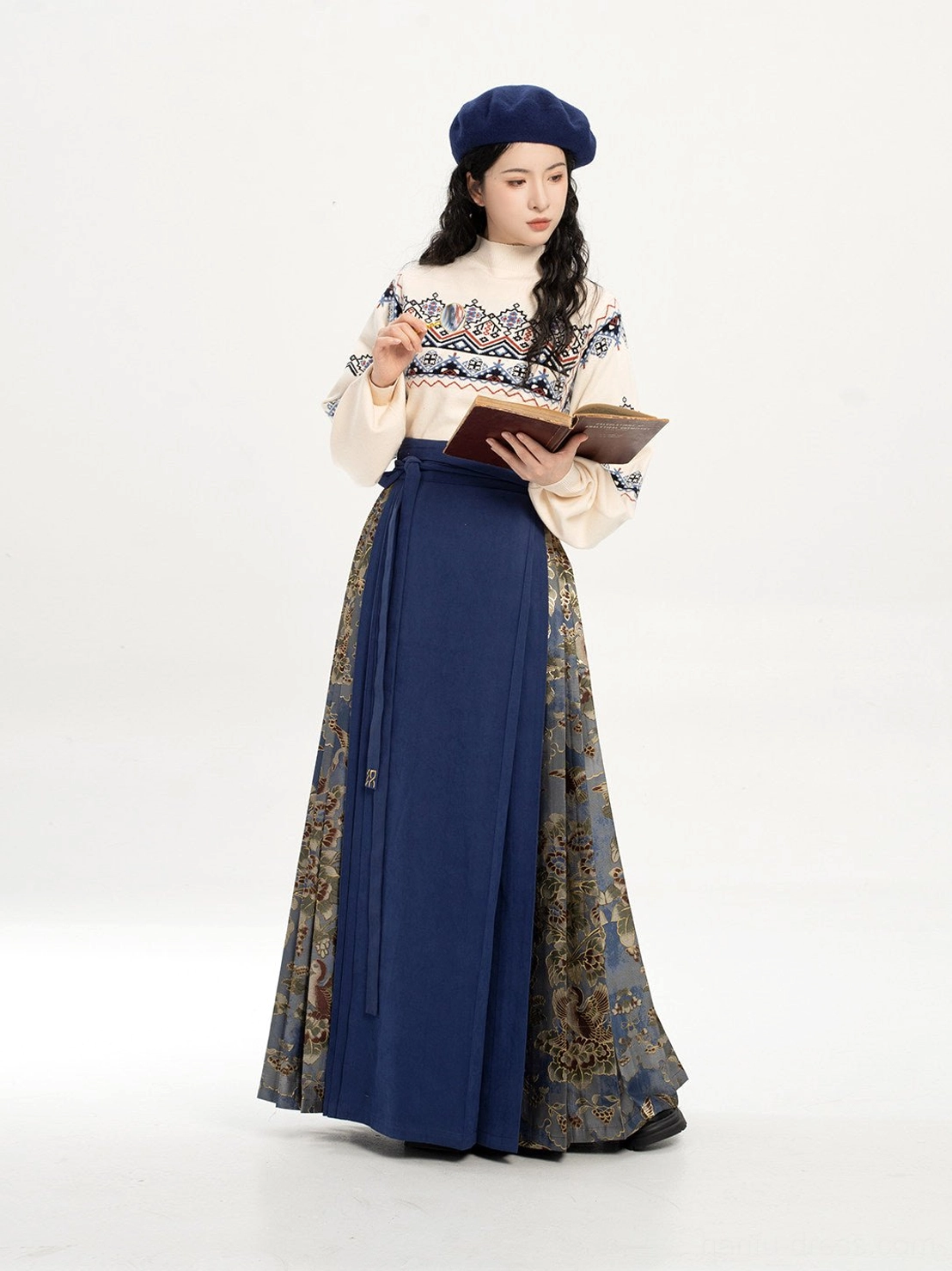 Front view of a navy blue Dunhuang-inspired mamianqun hanfu set styled with a blue beret and vintage book