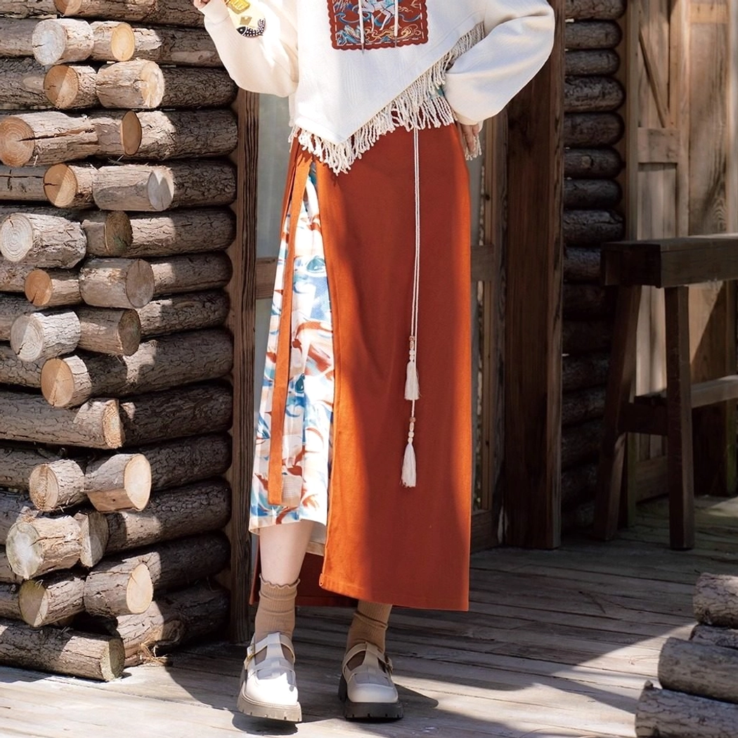 Back view of the Dunhuang Singing Deer modern Hanfu two-piece outfit showing the terracotta wrap skirt tassel drawstring and cropped sweater fringe