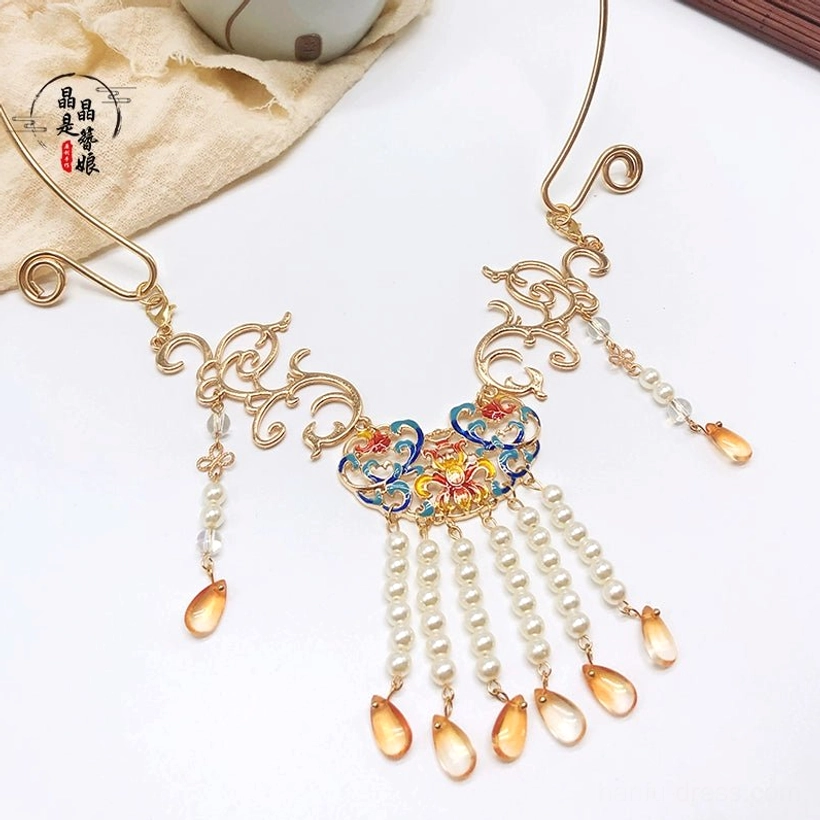 Full front flat lay of Dunhuang style tassel Chinese necklace with gold filigree frame, colorful floral pendant, pearls, and amber drops