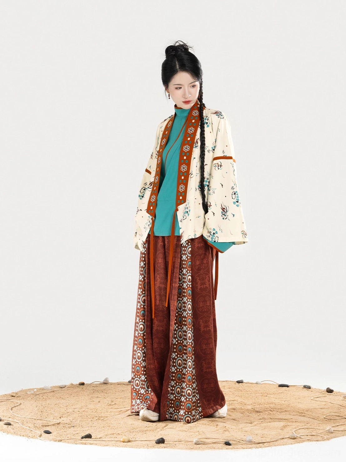 Side view of a flowing three-piece Dunhuang style women’s Hanfu ensemble with relaxed silhouette, cross-collar outer top, coordinated trims, and wide-leg trousers
