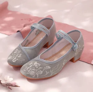 Dusty blue peony embroidered Hanfu shoes for women with double Chinese frog buckle ankle straps, low block heels, canvas uppers, and rubber soles